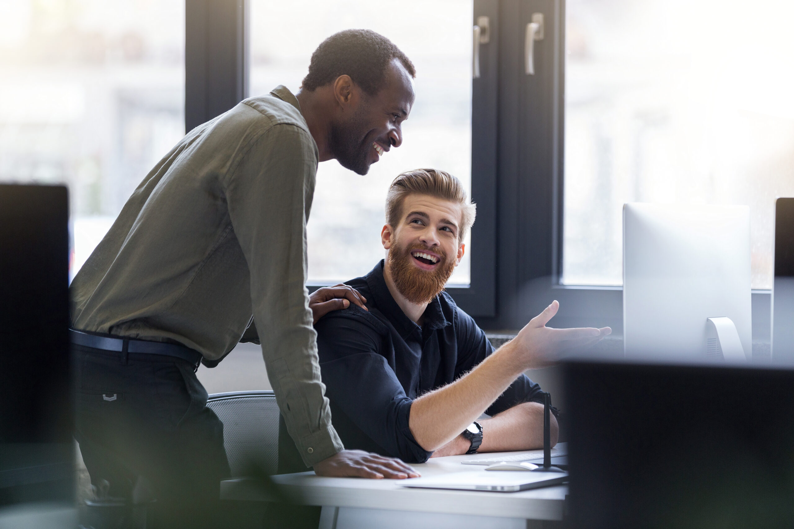 <br /> two-happy-men-working-together-new-business-project